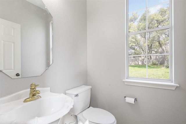 half bathroom with a sink and toilet