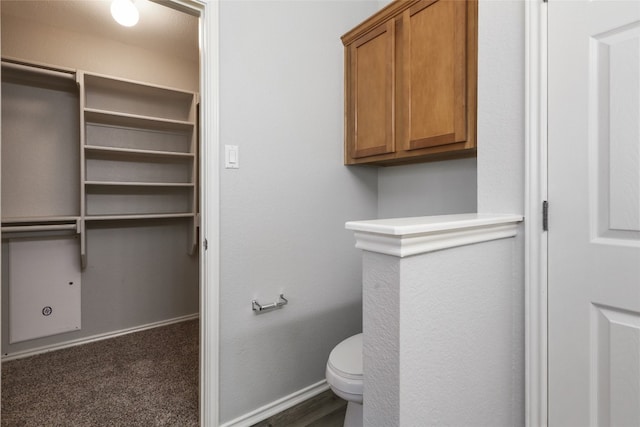 bathroom with toilet and baseboards