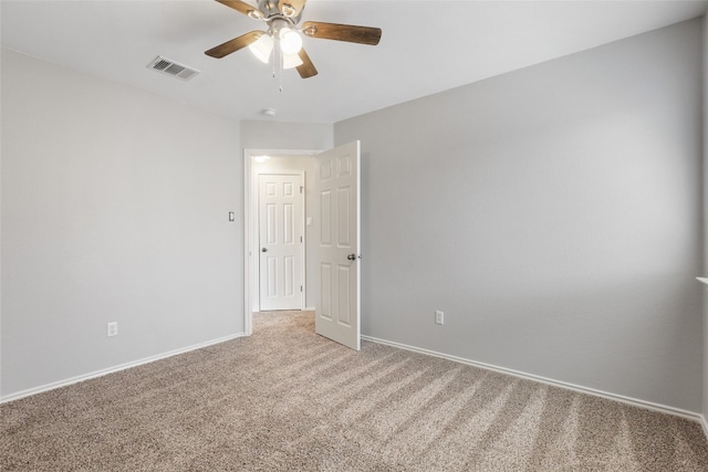 empty room featuring baseboards, visible vents, ceiling fan, and carpet flooring