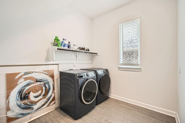 582 Wild Pecan Loop, Buda, TX 78610 - washroom featuring separate washer and dryer, baseboards, and light wood-type flooring