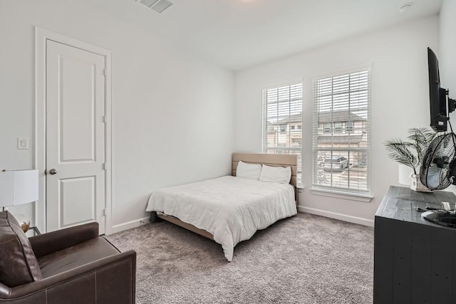 bedroom featuring light colored carpet, visible vents, and baseboards