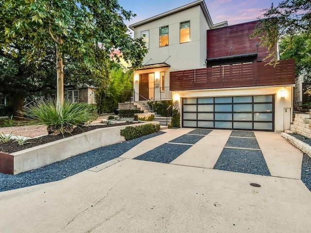 contemporary house with concrete driveway and stucco siding