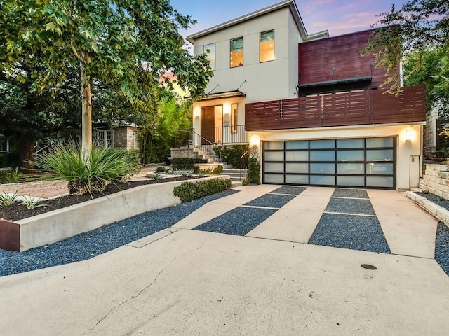 2312 W 8th St, Austin, TX 78703 - contemporary house with an attached garage, driveway, and stucco siding