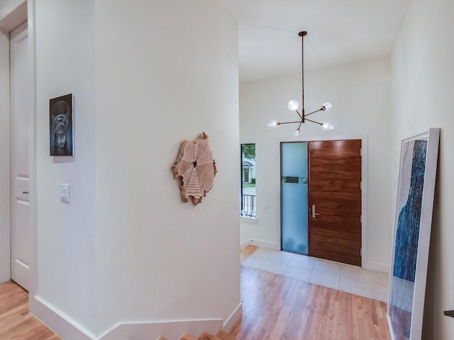 2312 W 8th St, Austin, TX 78703 - foyer entrance featuring wood finished floors, a chandelier, and baseboards
