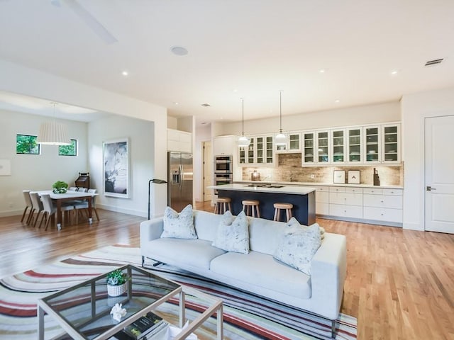 2312 W 8th St, Austin, TX 78703 - living area with light wood-style floors, baseboards, and recessed lighting