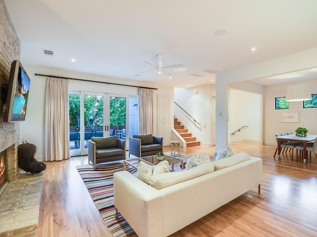 2312 W 8th St, Austin, TX 78703 - living room featuring a fireplace, stairway, light wood-style floors, ceiling fan, and recessed lighting