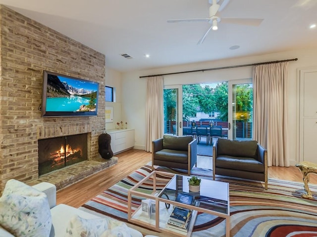 2312 W 8th St, Austin, TX 78703 - living room with a ceiling fan, a brick fireplace, wood finished floors, and recessed lighting