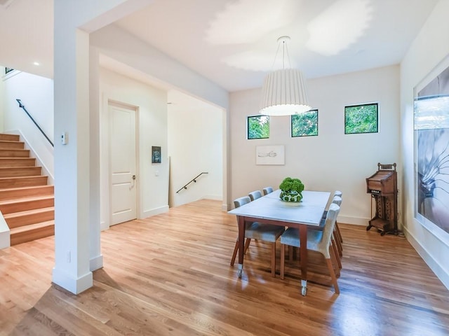 2312 W 8th St, Austin, TX 78703 - dining area with light wood-type flooring, stairway, and baseboards