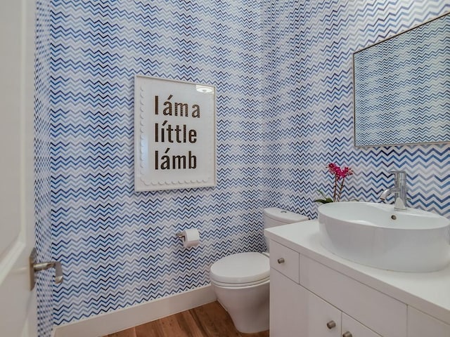 2312 W 8th St, Austin, TX 78703 - half bathroom featuring wood finished floors, toilet, tile walls, and vanity