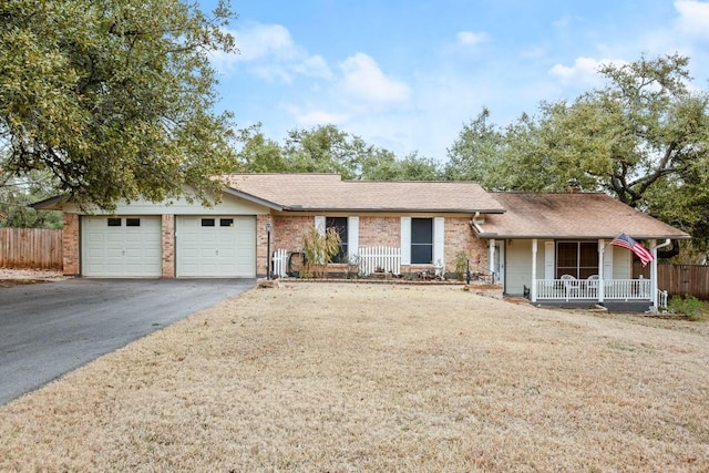 ranch-style house featuring driveway, a porch, an attached garage, and fence