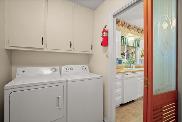 clothes washing area with cabinet space and washing machine and clothes dryer