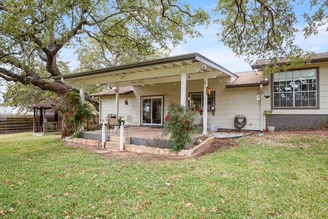 single story home with fence, a front lawn, and a patio