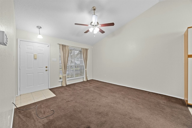 entrance foyer featuring a ceiling fan, carpet, vaulted ceiling, and baseboards