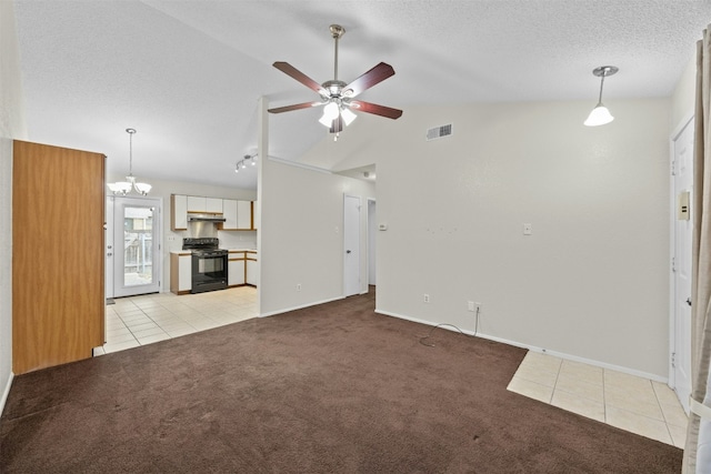 unfurnished living room with light tile patterned floors, visible vents, a ceiling fan, light carpet, and a textured ceiling