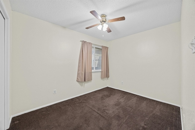 empty room with a textured ceiling, carpet floors, a ceiling fan, and baseboards