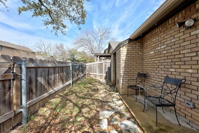 view of yard featuring a patio area and a fenced backyard