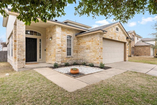 single story home with driveway, a front lawn, an attached garage, and stone siding