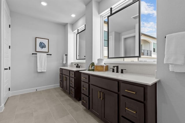 11 Doverland Dr, Lakeway, TX 78738 - bathroom featuring double vanity, baseboards, recessed lighting, and tile patterned flooring