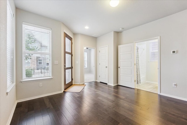 foyer entrance featuring baseboards, dark wood-style flooring, and recessed lighting