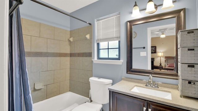 bathroom featuring a ceiling fan, toilet, shower / bathtub combination with curtain, and vanity