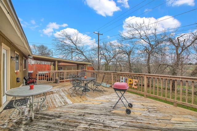 wooden deck featuring outdoor dining area