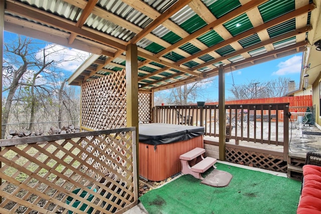 wooden deck featuring fence and a hot tub