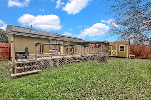 1713 Parkside Cir, Round Rock, TX 78664 - rear view of house featuring a storage shed, roof mounted solar panels, a fenced backyard, and a wooden deck