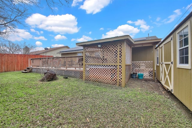 view of yard with fence and a deck