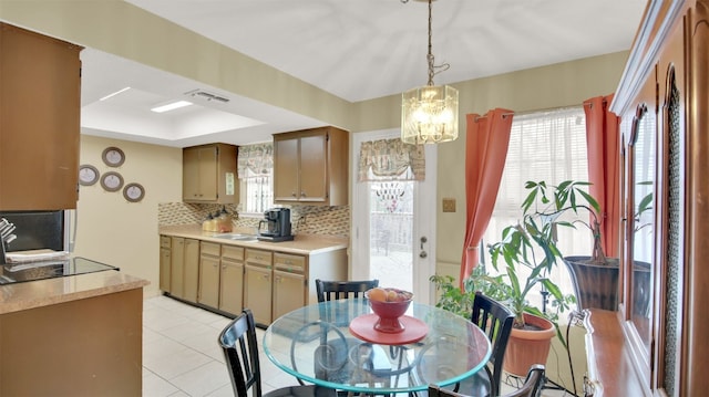 dining area with a healthy amount of sunlight, visible vents, a notable chandelier, and light tile patterned flooring