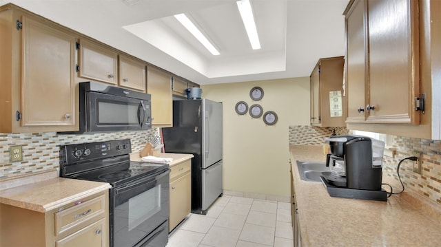 kitchen with tasteful backsplash, light countertops, black appliances, and light tile patterned flooring