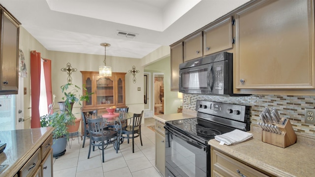 kitchen with visible vents, decorative backsplash, hanging light fixtures, light countertops, and black appliances