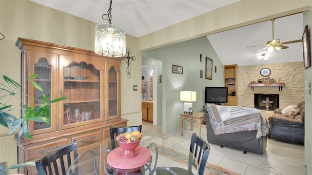 1713 Parkside Cir, Round Rock, TX 78664 - dining area featuring light tile patterned floors, ceiling fan, a large fireplace, a chandelier, and vaulted ceiling