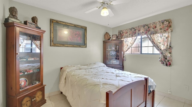 bedroom with ceiling fan, baseboards, and light tile patterned flooring