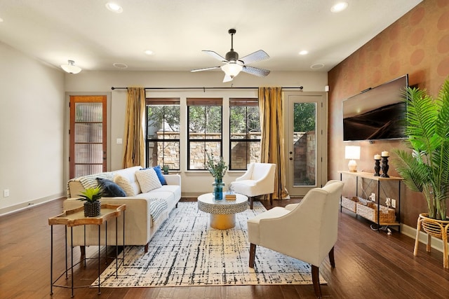 living area with dark wood-type flooring, recessed lighting, and baseboards