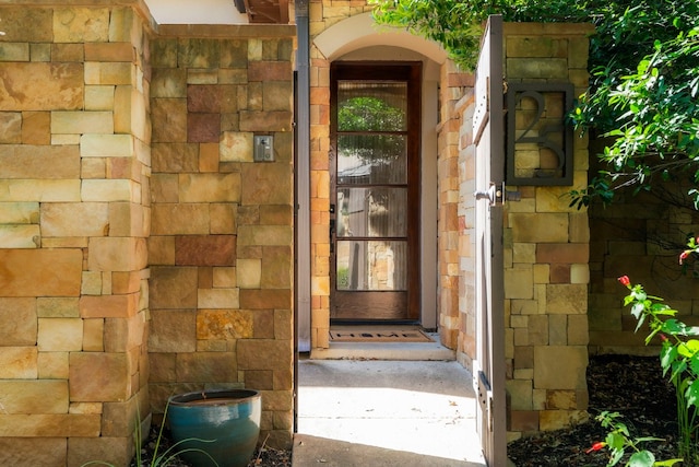 view of exterior entry featuring stone siding