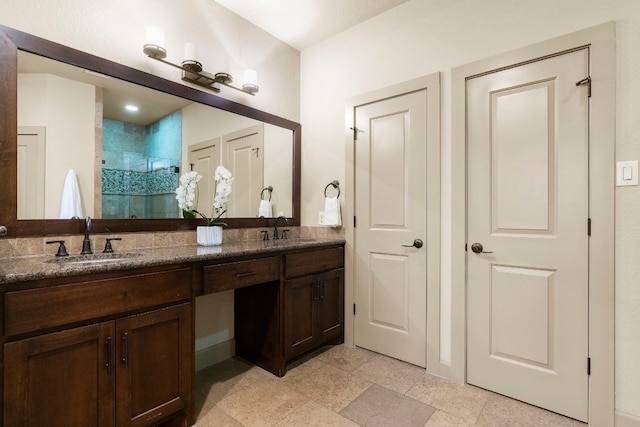 bathroom with double vanity, a sink, and a shower stall