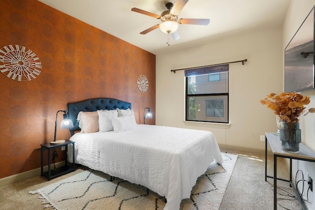 bedroom with baseboards, wallpapered walls, a ceiling fan, and light colored carpet