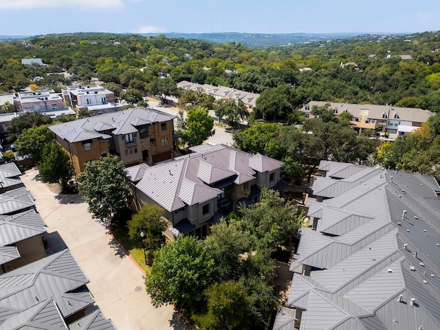 bird's eye view featuring a residential view and a wooded view