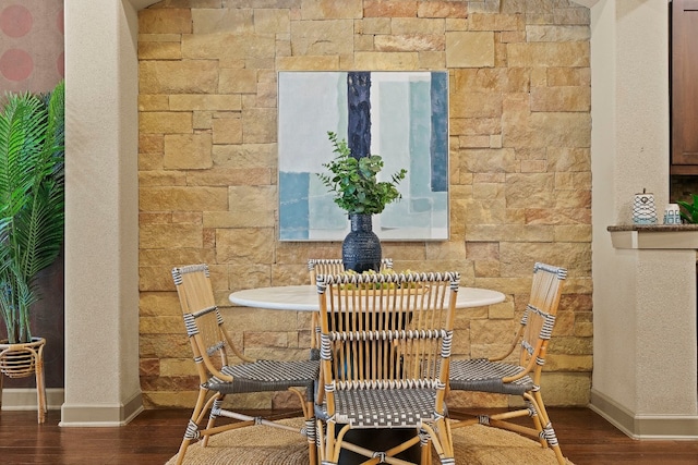 dining area featuring dark wood-style floors and baseboards