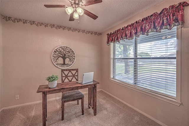 home office with carpet floors, ceiling fan, baseboards, and a textured ceiling