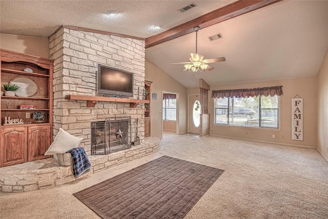 carpeted living room featuring visible vents, a fireplace, lofted ceiling with beams, and a textured ceiling
