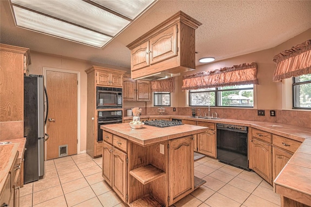 kitchen with tile countertops, light tile patterned flooring, open shelves, a kitchen island, and black appliances