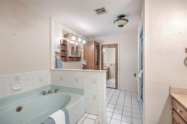 full bath featuring visible vents, tile patterned floors, a textured ceiling, vanity, and a bath