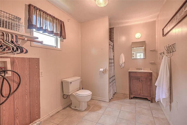 full bath featuring curtained shower, toilet, wooden walls, vanity, and tile patterned floors