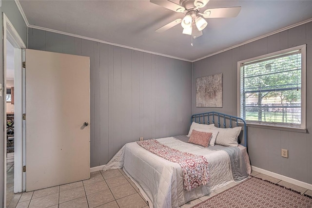 bedroom featuring ceiling fan, baseboards, crown molding, and light tile patterned flooring