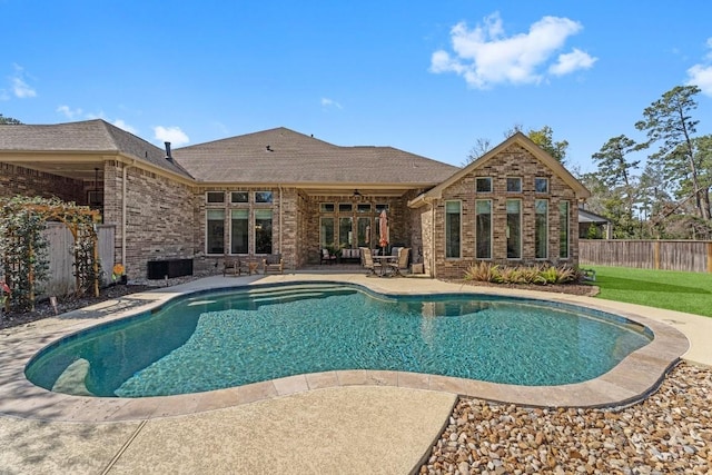 view of swimming pool with a fenced in pool, fence, and a patio