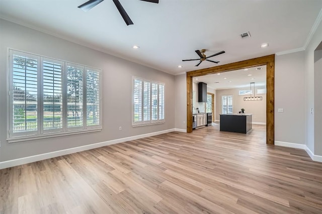 102 Blue Sky Ct, Georgetown, TX 78633 - unfurnished living room with a ceiling fan, ornamental molding, light wood-type flooring, and recessed lighting