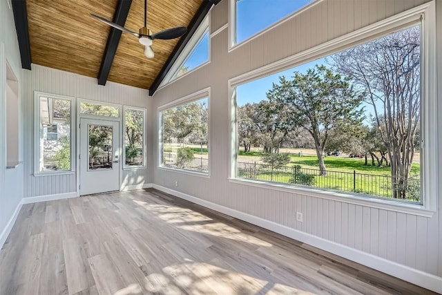 unfurnished sunroom with baseboards, wooden ceiling, wood finished floors, and beamed ceiling