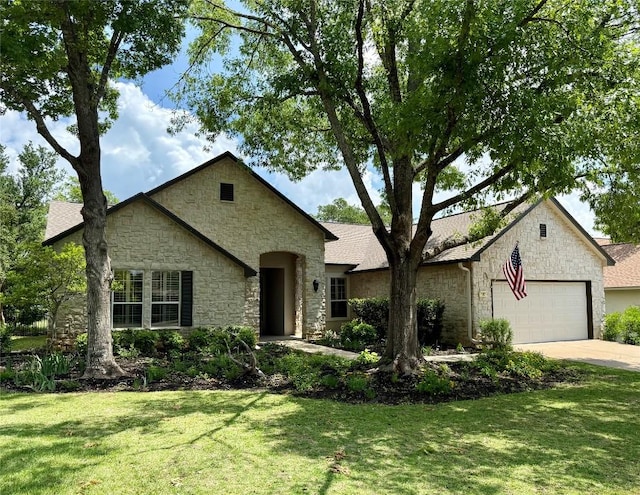 view of front facade featuring a front lawn, an attached garage, and stone siding
