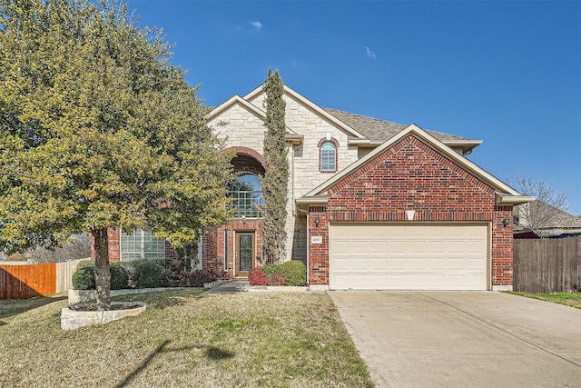 traditional-style house with an attached garage, brick siding, fence, concrete driveway, and a front yard